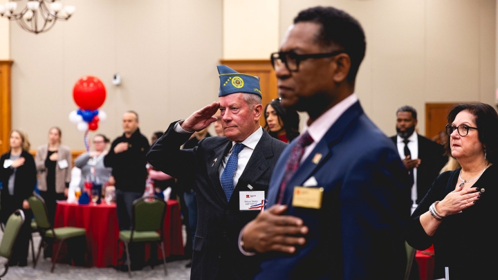 A veteran salutes the flag during the Pledge of Allegiance