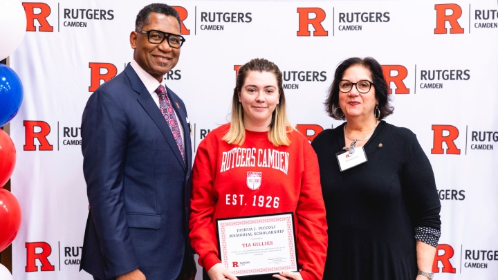 Student Tia Gillies receives a scholarship during the 2024 Chancellor's Veterans Day Luncheon